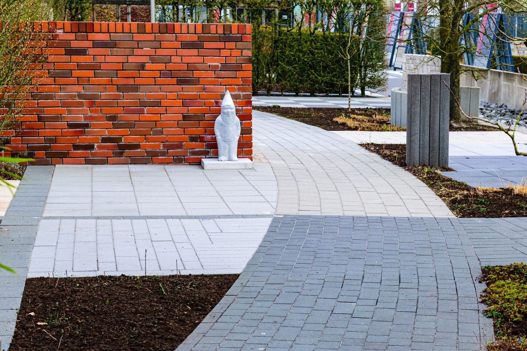 Brick garden wall and curved paver walkway